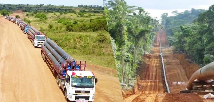 East African Crude Oil Pipeline with industrial pumps and heated infrastructure at construction site East African Crude Oil Pipeline with industrial pumps and heated infrastructure at construction site.